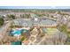 An aerial view shows the community clubhouse, pool, tennis court, and surrounding neighborhood at 144 Sabiston Ct, Cary, NC 27519