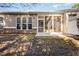 The back of the house has a screened-in porch, a patio, and a yard with grass and fallen leaves at 144 Sabiston Ct, Cary, NC 27519