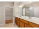 A bathroom features double sinks with a vanity and a framed mirror, as well as a glass shower at 144 Sabiston Ct, Cary, NC 27519