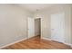 A bedroom features hardwood floors and access to a closet and a door that leads to the hallway at 144 Sabiston Ct, Cary, NC 27519