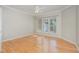 Empty bedroom with hardwood floors, and a large window at 144 Sabiston Ct, Cary, NC 27519