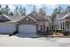 Charming home featuring a brick facade, two-car garage, and manicured landscaping at 144 Sabiston Ct, Cary, NC 27519