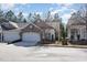 A well-maintained home boasting a brick facade, two-car garage, and picturesque surroundings at 144 Sabiston Ct, Cary, NC 27519