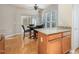 Kitchen and dining area with granite counters, wood cabinets, and natural light at 144 Sabiston Ct, Cary, NC 27519