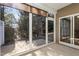 A screened porch with a concrete floor and screen windows shows the exterior backyard and sunlight at 144 Sabiston Ct, Cary, NC 27519