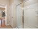 A glass shower features a white shower surround, silver trim, and a clear glass sliding door at 144 Sabiston Ct, Cary, NC 27519