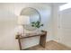 Cozy entryway with wood accents, round mirror, and a stylish lamp creating a welcoming ambiance at 1481 Hasse Ave, Apex, NC 27502