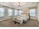 Spacious main bedroom with plush carpet, bench seat, and bright, natural light at 1481 Hasse Ave, Apex, NC 27502
