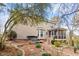 Back of house featuring screened-in porch, hot tub and deck, all set in a well-landscaped backyard at 153 Dell Meadows Pl, Four Oaks, NC 27524