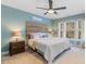 Cozy bedroom featuring wood headboard, neutral carpet, and ceiling fan at 153 Dell Meadows Pl, Four Oaks, NC 27524