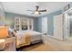 Spacious bedroom offers a large window, neutral carpet, and ceiling fan at 153 Dell Meadows Pl, Four Oaks, NC 27524