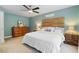 Bright bedroom offers a wood accent wall, neutral carpet, and ceiling fan at 153 Dell Meadows Pl, Four Oaks, NC 27524