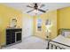 Sunny bedroom featuring yellow walls, carpet floors, and a ceiling fan at 153 Dell Meadows Pl, Four Oaks, NC 27524