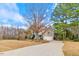 Well-situated home with long driveway, complemented by mature trees and lush landscaping at 153 Dell Meadows Pl, Four Oaks, NC 27524
