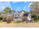 Inviting home with solar panels, complemented by mature trees and lush landscaping at 153 Dell Meadows Pl, Four Oaks, NC 27524