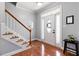 Elegant foyer with hardwood floors, a staircase, and a view of the front door at 153 Dell Meadows Pl, Four Oaks, NC 27524