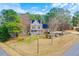 Charming two-story home featuring a well-maintained front yard, mature trees, and a welcoming front porch at 153 Dell Meadows Pl, Four Oaks, NC 27524