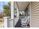 Inviting front porch featuring rocking chairs, perfect for relaxing outdoors at 153 Dell Meadows Pl, Four Oaks, NC 27524