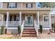 Close up of a charming front porch with brick steps and classic white columns at 153 Dell Meadows Pl, Four Oaks, NC 27524