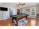 An inviting game room offering a billiards table and an abundance of light throughout the space at 153 Dell Meadows Pl, Four Oaks, NC 27524