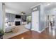Open-concept living room with hardwood floors and views into dining and sun room at 153 Dell Meadows Pl, Four Oaks, NC 27524