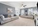 Spacious living room featuring neutral paint, ceiling fan, and ample natural light, ideal for relaxation and gatherings at 153 Dell Meadows Pl, Four Oaks, NC 27524