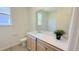 Well-lit bathroom featuring a single sink vanity with quartz countertop and wood-look cabinets, offering a functional and stylish space at 158 Gobbler Dr, Smithfield, NC 27577