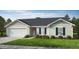 Charming single-story home with a two-car garage, light beige siding, and well-manicured front lawn at 158 Gobbler Dr, Smithfield, NC 27577