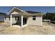 The back of a modern-style home featuring a covered patio and large windows for ample natural light at 158 Gobbler Dr, Smithfield, NC 27577