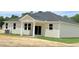 Home exterior featuring windows, siding, and a well-maintained yard at 158 Gobbler Dr, Smithfield, NC 27577