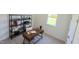 Charming home office with a wood desk, stylish shelving unit, and natural light from the window, perfect for remote work at 158 Gobbler Dr, Smithfield, NC 27577