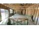 Spacious living room showcasing a sliding glass door and unfinished walls and ceiling at 158 Gobbler Dr, Smithfield, NC 27577