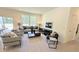 Bright living room featuring neutral walls, plush carpet, and large windows providing natural light and access to the outdoors at 158 Gobbler Dr, Smithfield, NC 27577
