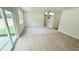 Open concept space features a dining area with modern chandelier, sliding doors, and carpeted living room at 158 Gobbler Dr, Smithfield, NC 27577
