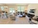 Comfortable living room with large windows, modern furniture, and open to the dining area at 158 Gobbler Dr, Smithfield, NC 27577