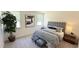 Cozy main bedroom with plush carpet, natural light, and a comfortable bed with stylish striped bedding and upholstered headboard at 158 Gobbler Dr, Smithfield, NC 27577