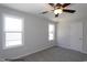 Comfortable bedroom with neutral tones, two windows for natural light, and a ceiling fan at 183 W Saltgrass Ln, Smithfield, NC 27577
