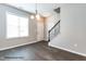 Inviting entryway with hardwood floors, staircase with iron railing, and natural light from a large window at 183 W Saltgrass Ln, Smithfield, NC 27577