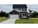 Two-story home featuring a two-car garage, gray siding, and a well-maintained lawn at 183 W Saltgrass Ln, Smithfield, NC 27577