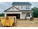 Two-story home under construction with visible frame and building materials, showcasing the early stages of construction at 183 W Saltgrass Ln, Smithfield, NC 27577