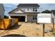 Exterior view of a two-story home showcasing its construction progress and architectural details at 183 W Saltgrass Ln, Smithfield, NC 27577