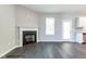 Spacious living room with a fireplace, hardwood floors, and sliding glass door leading to the outdoor space at 183 W Saltgrass Ln, Smithfield, NC 27577