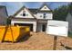 New two-story home featuring a dark roof, visible underlayment, and a two-car garage awaiting personalization at 197 W Saltgrass Ln, Smithfield, NC 27577