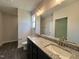Bathroom features a double sink vanity with granite countertops and modern fixtures at 201 W Saltgrass Ln, Smithfield, NC 27577