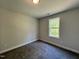 A minimalist bedroom with soft carpet and big windows to enjoy a fantastic view of the outdoors at 201 W Saltgrass Ln, Smithfield, NC 27577