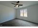 Clean bedroom features ceiling fan, window with view and neutral carpeting at 201 W Saltgrass Ln, Smithfield, NC 27577
