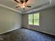 Inviting bedroom offers plush carpeting, a tray ceiling, and a large window overlooking the green backyard at 201 W Saltgrass Ln, Smithfield, NC 27577