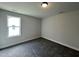 Carpeted bedroom with a window and neutral tones at 201 W Saltgrass Ln, Smithfield, NC 27577