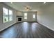 Spacious living room with hardwood floors, a fireplace, and big windows showcasing a neighborhood view at 201 W Saltgrass Ln, Smithfield, NC 27577