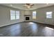 Bright living room boasts luxury vinyl plank floors, a fireplace, and large windows for natural light at 201 W Saltgrass Ln, Smithfield, NC 27577